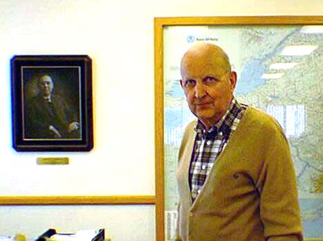 Bernard 'Bud' Bannigan with photo of Michael T. Bannigan, founder, in background.